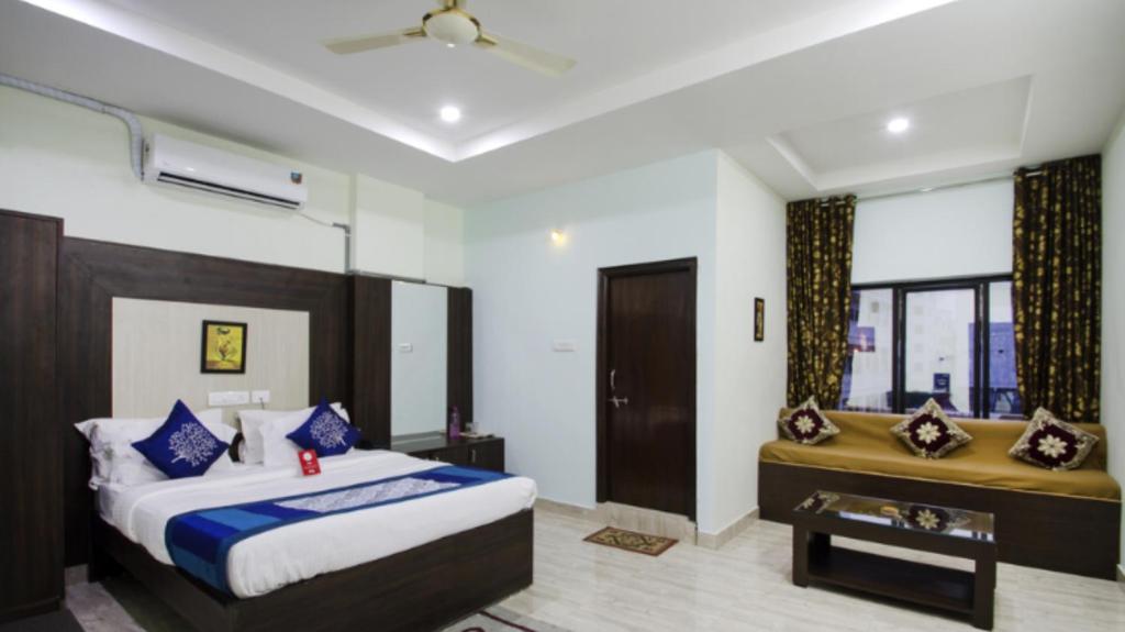 a bedroom with a large bed and a window at Aurum Abodes in Hyderabad