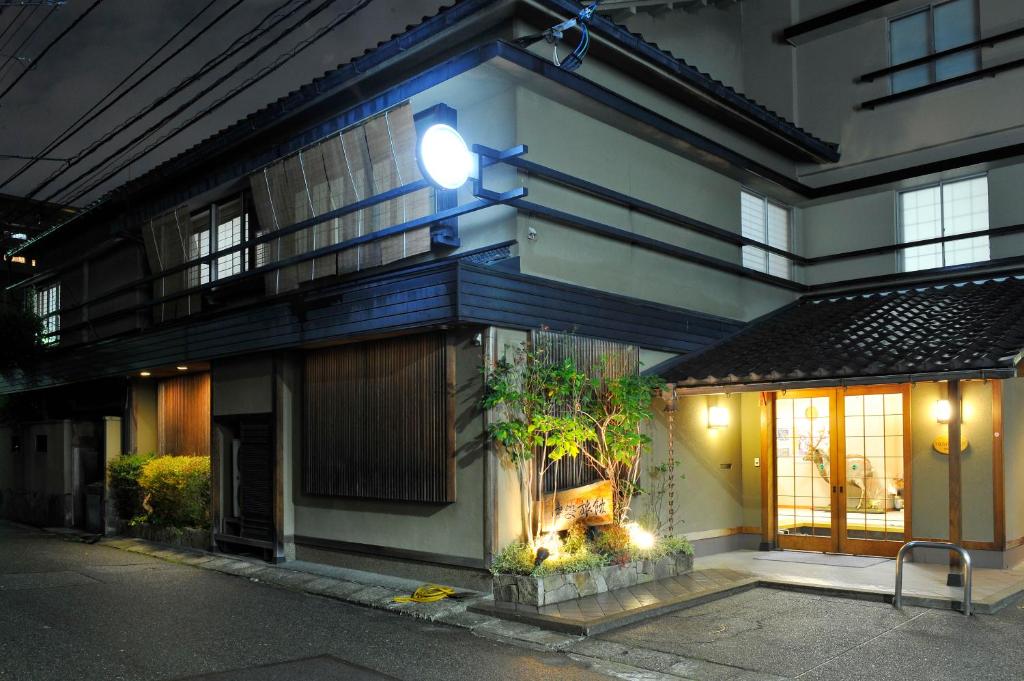 a building with a light on the side of it at Nakayasu Ryokan in Kanazawa