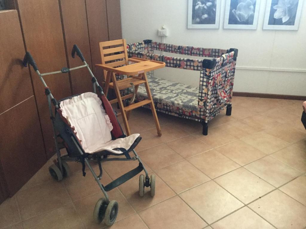a room with a table and a wheelchair and a table and chairs at Chicco Frau appartamenti trattati con OZONO in Fluminimaggiore