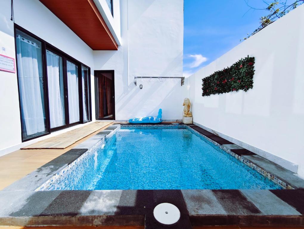 a swimming pool in the middle of a house at Joy Private Pool Villa in Kuta