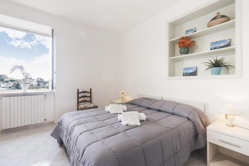 a bedroom with a large bed and a window at Scala Center big holiday house in Scala