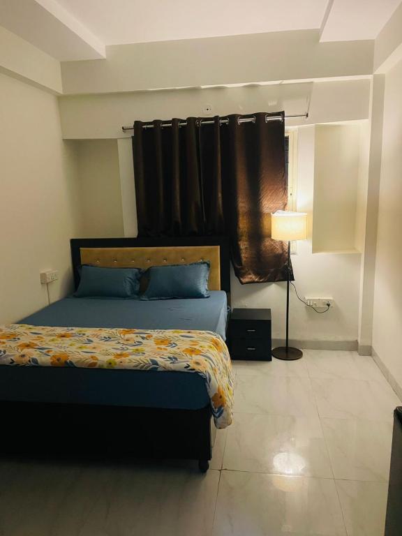 a bedroom with a bed and a window at Staywise in Indore