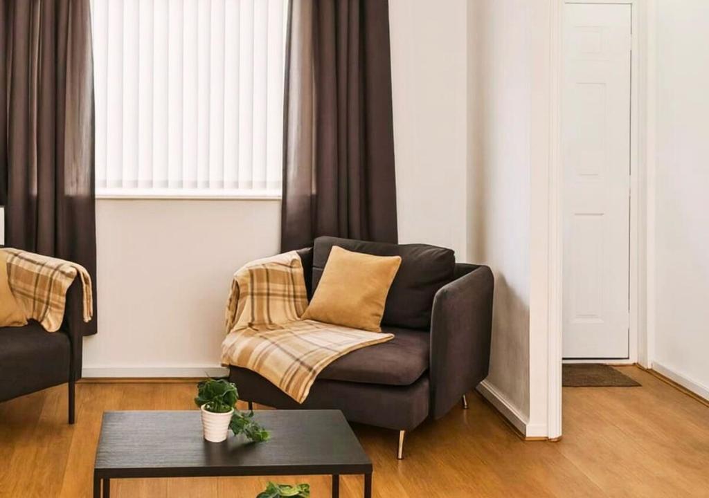 a living room with a couch and a table at Matchday Mile House Walk to Anfield sleeps 8 in Liverpool