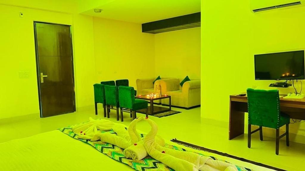 a yellow living room with a toy snake laying on the floor at The Hotel Am Bliss in Gurgaon