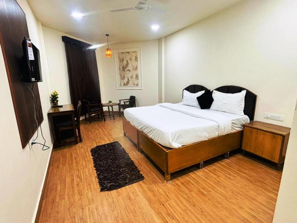 a bedroom with a bed and a television in it at Ruchi resort in Hisār