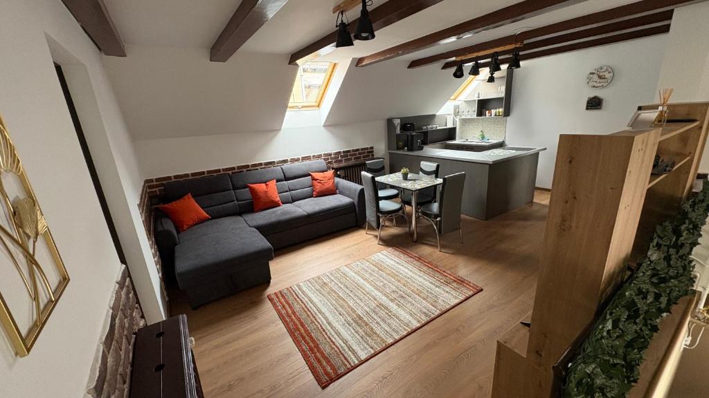 a living room with a couch and a table at My Central Home in Miercurea-Ciuc