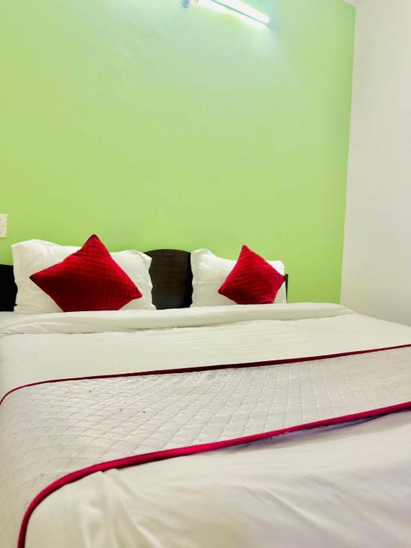 a bed with red and black pillows on it at Angel paradise in Jaipur