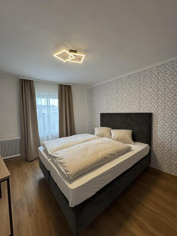 a bedroom with a large bed and a window at rooms11 in Salzburg