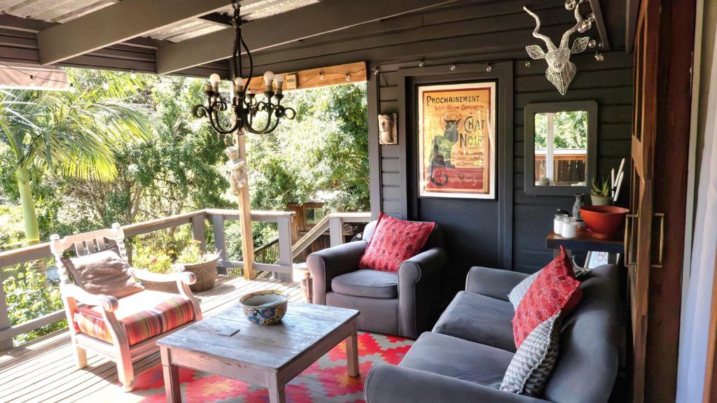 a screened in porch with chairs and a table at Riverfront Guesthouse ,Watermeadows farm in Sedgefield