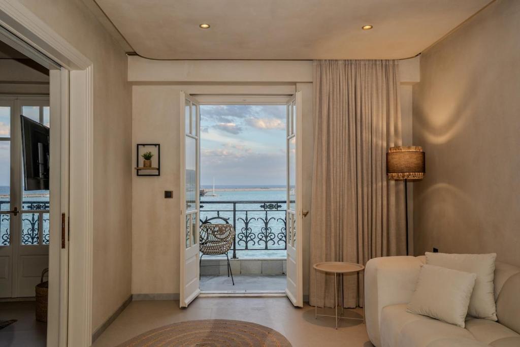 a living room with a couch and a view of the ocean at Bosi Suites 2 in Zakynthos