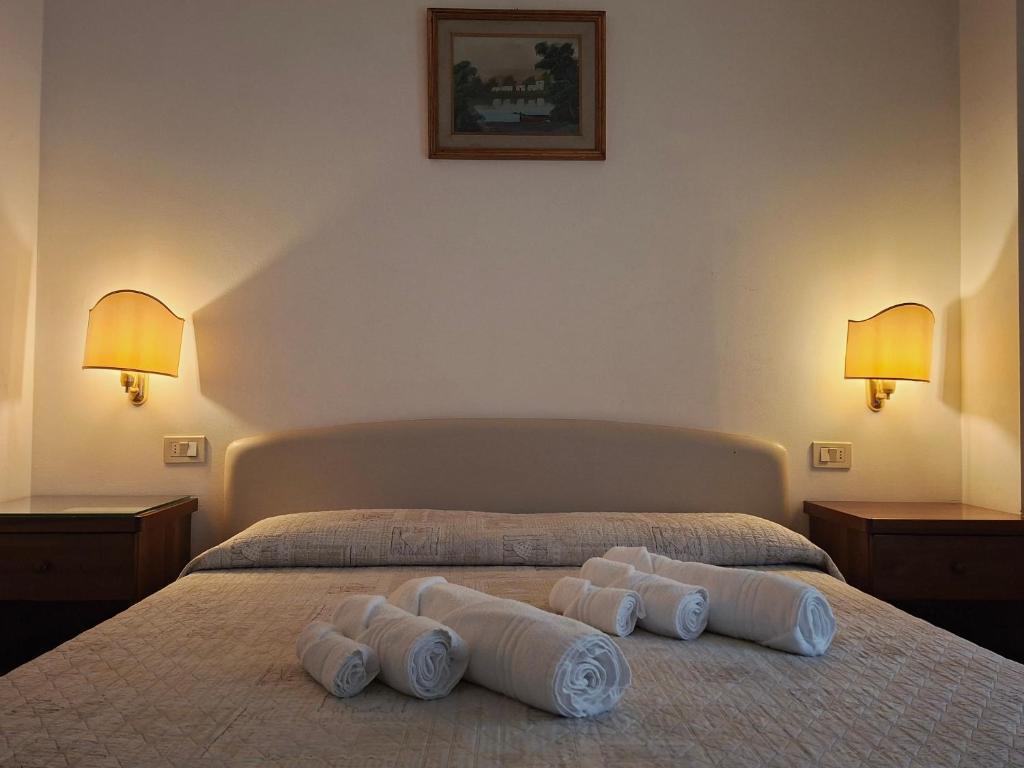 a hotel room with a bed with towels on it at Alloggi Venca' in Chioggia
