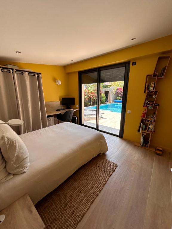 a bedroom with a large bed and a sliding glass door at Villa Bartolini in Bruges