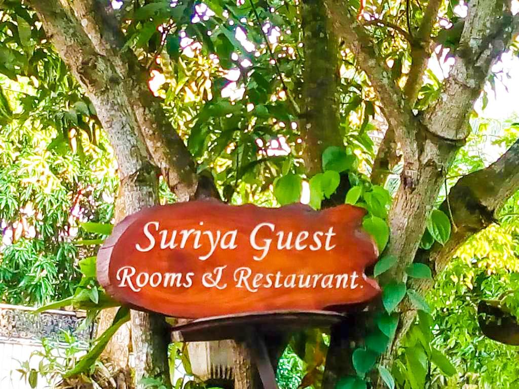 a sign on a tree in front of a tree at Suriya Homestay Mirissa in Mirissa