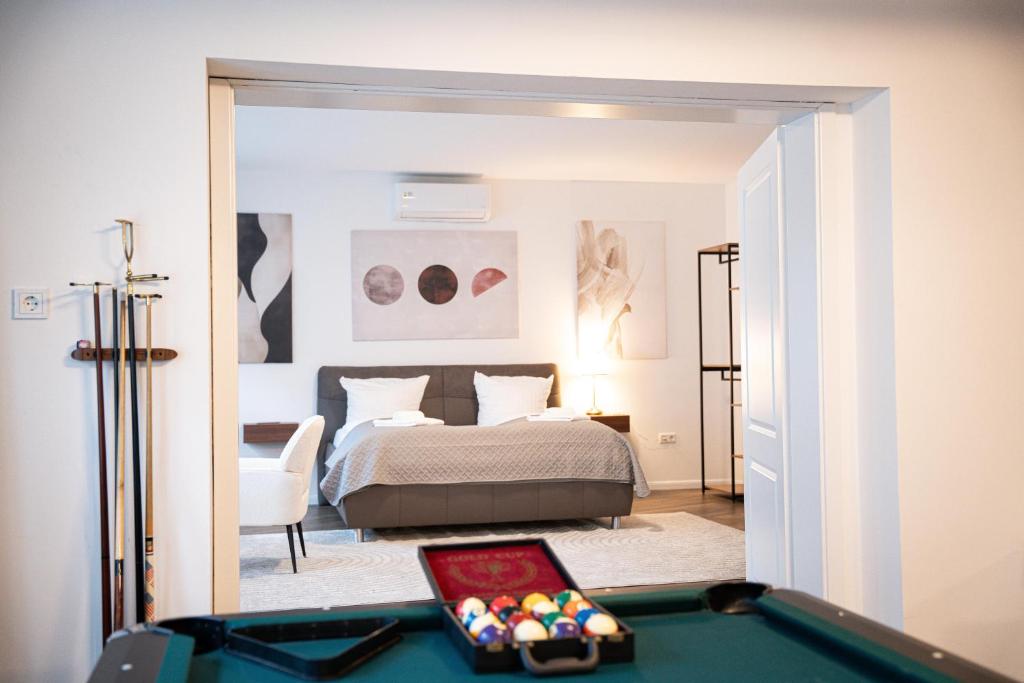 a bedroom with a bed and a pool table at Design Apartments Schloss Burg Solingen - BRIGHT Collection in Solingen
