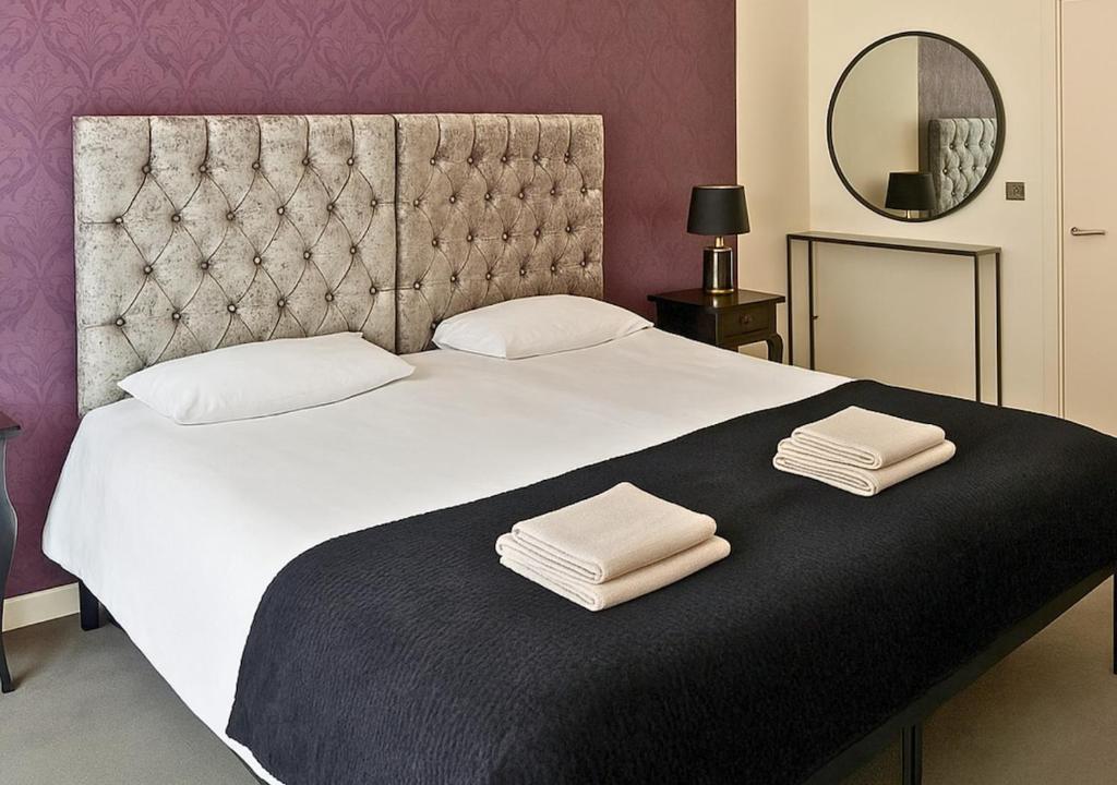 a bedroom with a large bed with two towels on it at The Vault Liverpool City Centre sleeps 4 in Liverpool