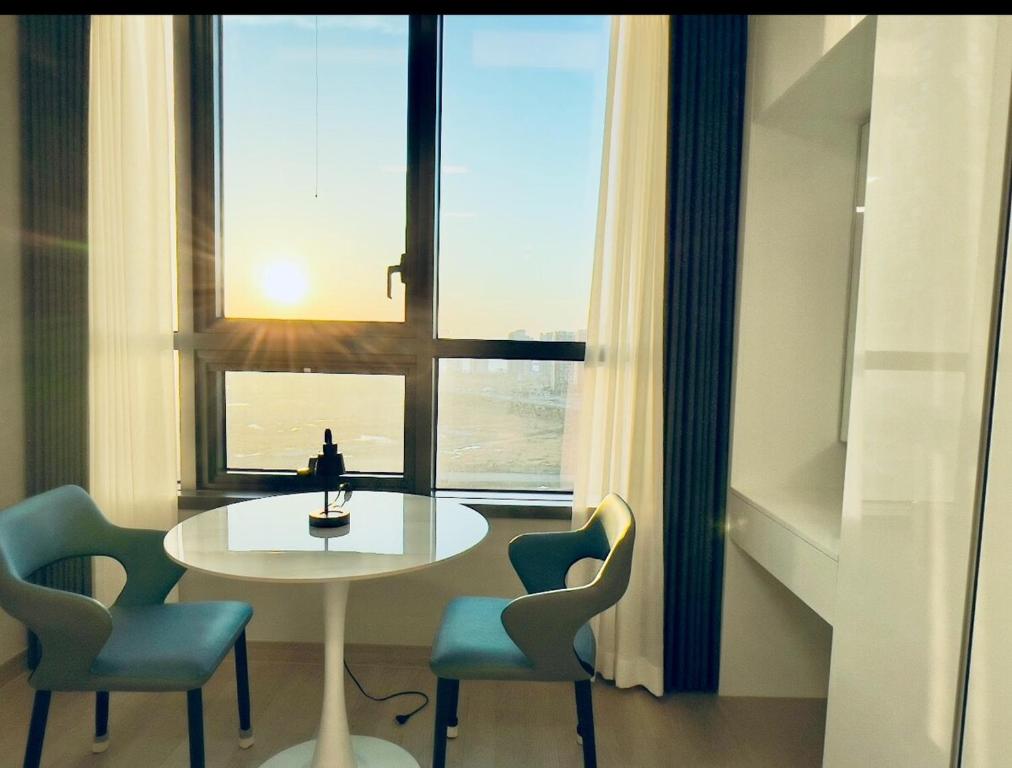 a table and chairs in a room with a window at Incheon Rest Stay in Taeam