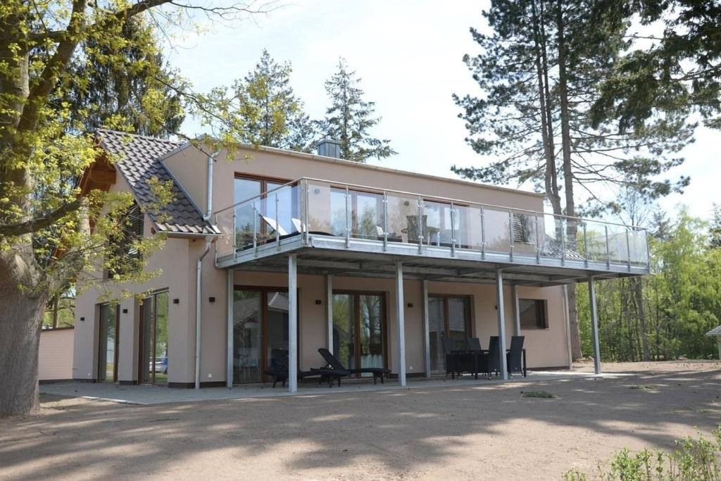a house with a balcony on top of it at Edith in Lenz