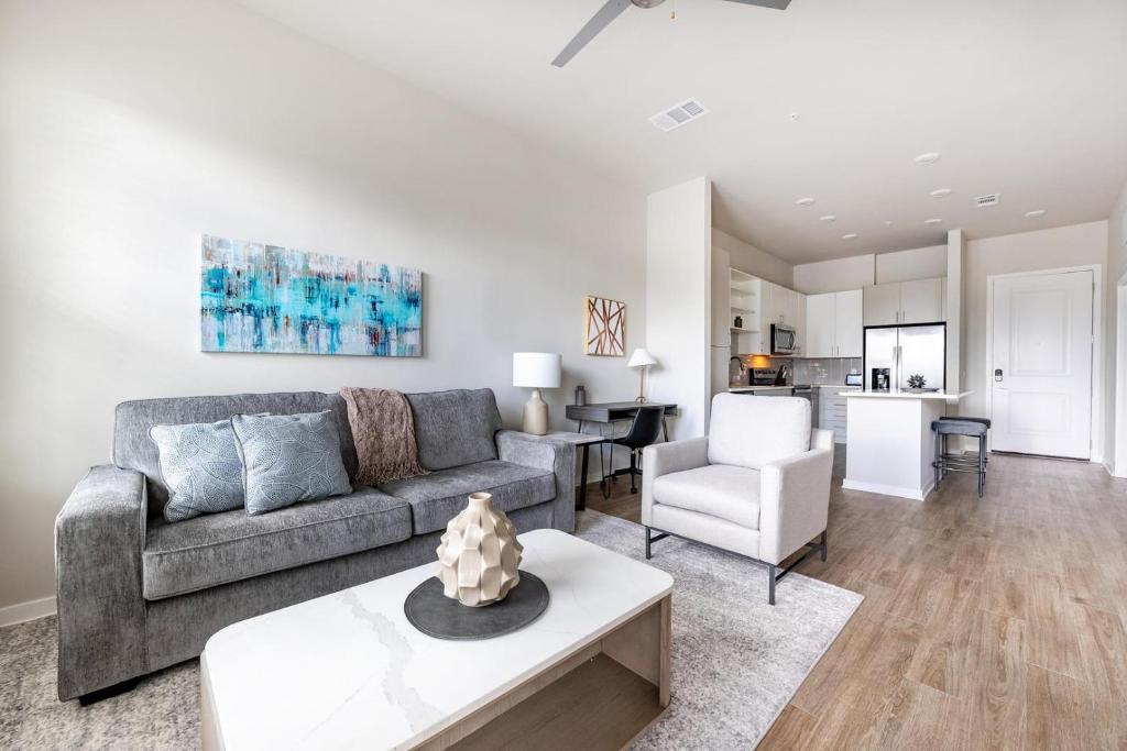 a living room with a couch and a table at Landing Apartments - Sereno in Wimauma