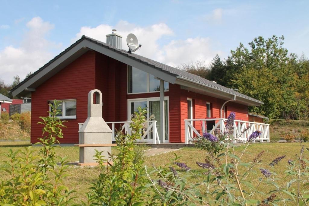 a red house with a satellite on the roof at Trine in Lenz