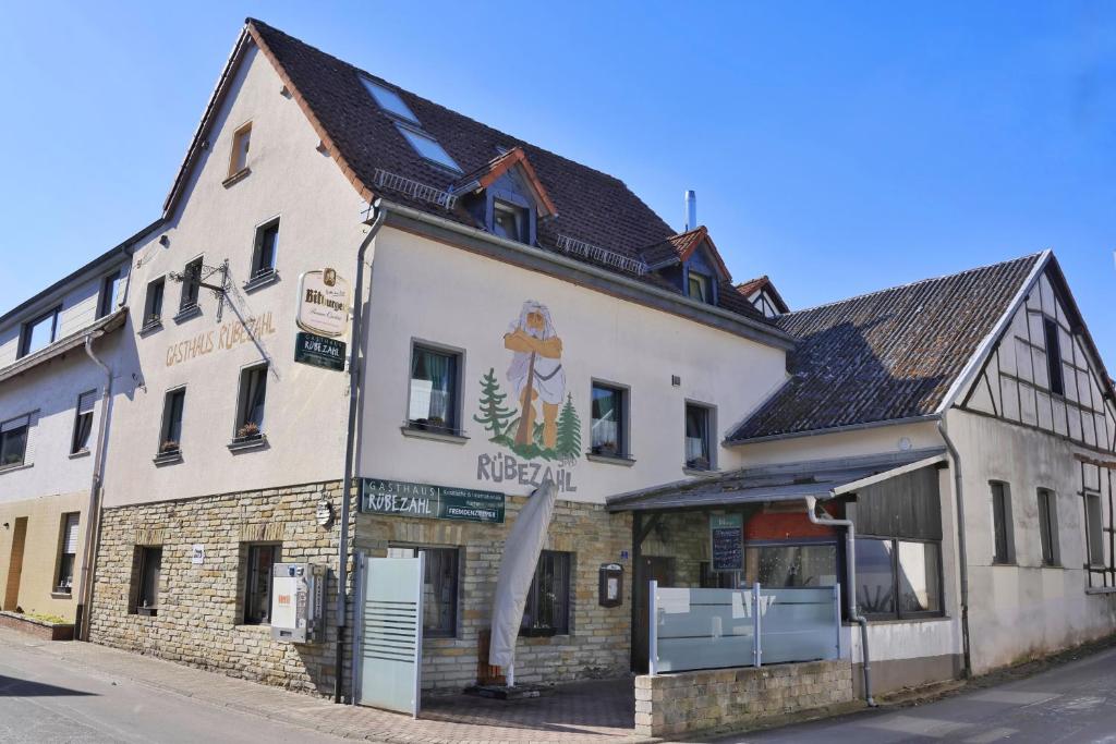 a large white building on the side of a street at Pension Schiffer in Blankenheim
