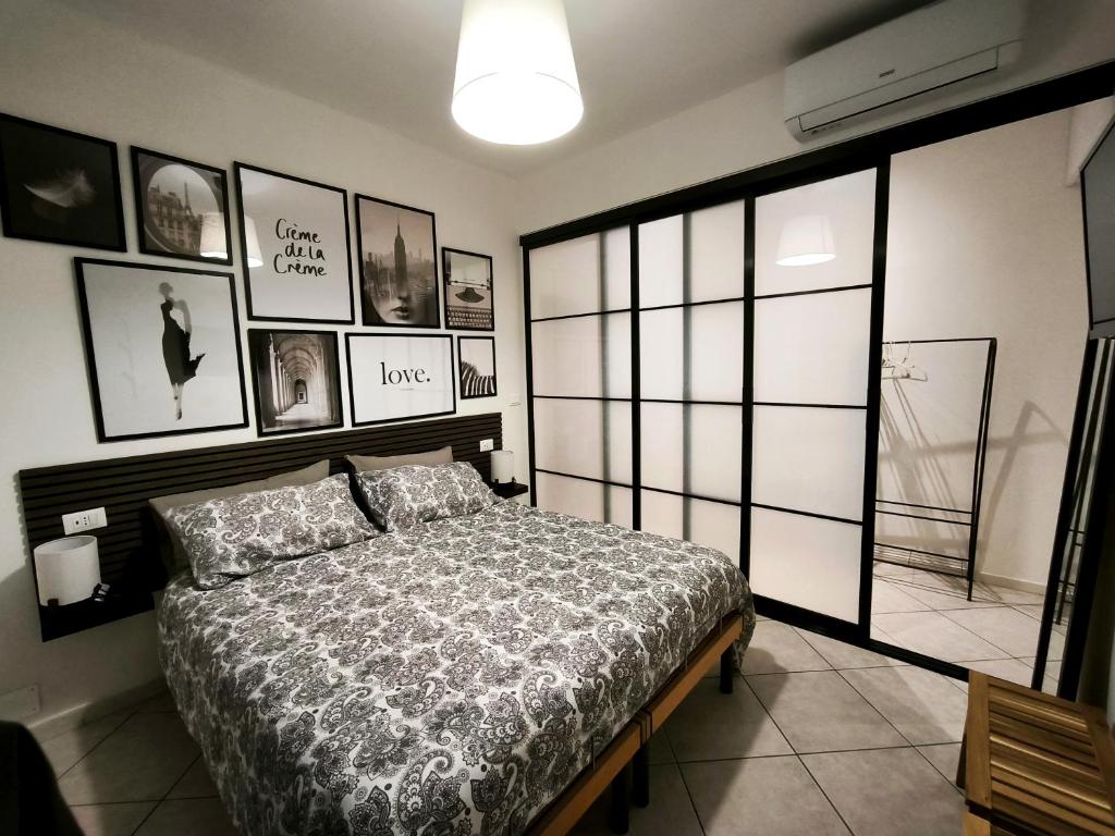 a bedroom with a bed and pictures on the wall at Casa André Imola in Imola