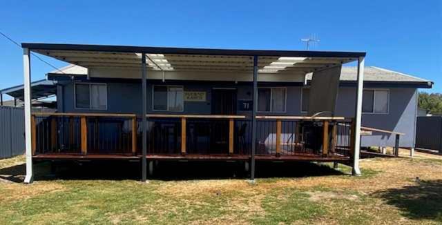 a house with a large deck in front of it at Cervantes 4 G Ranch in Cervantes