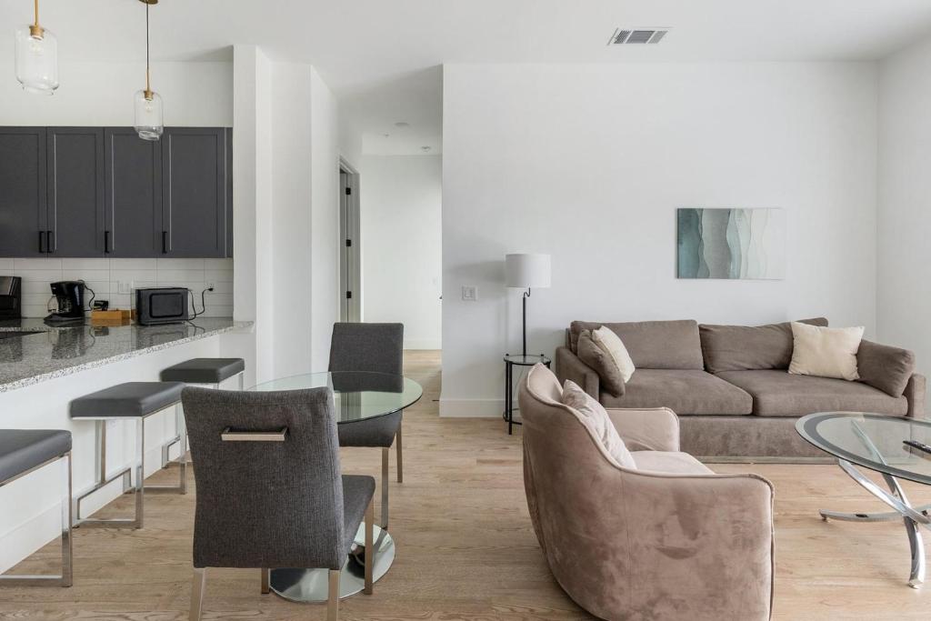 a living room with a couch and a table at Landing Chic 3BD Clubhouse Pool in Denton