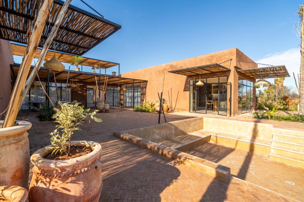 a building with a patio with a potted plant at VILLA 2s in Marrakesh