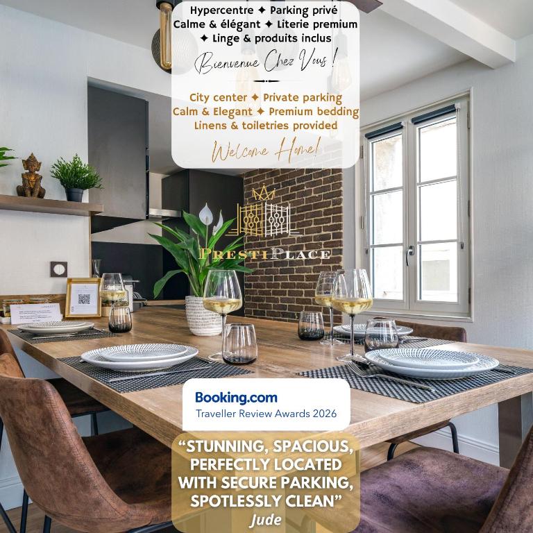 a dining room with a wooden table with chairs at Le Baleschoux - PrestiPlace Collection in Tours