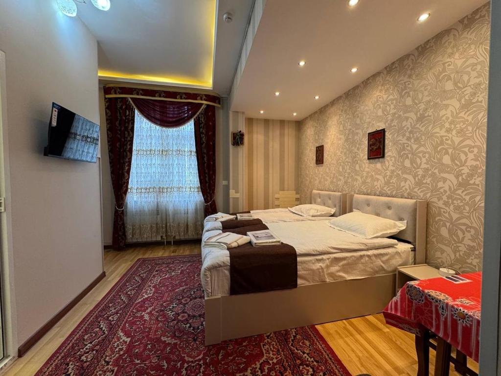 a bedroom with a large bed and a window at Узбечка in Tashkent