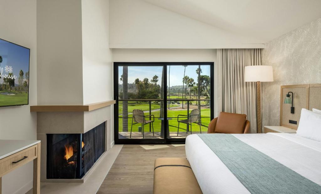 a hotel room with a bed and a fireplace at Guesthouse Hotel at La Valle in Rancho Santa Fe