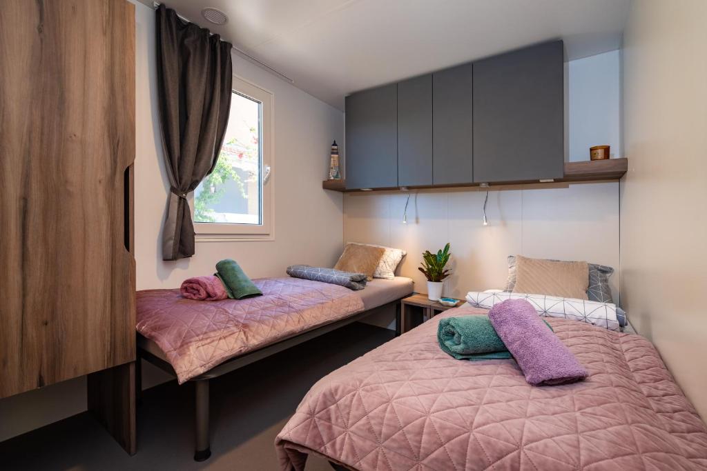 a bedroom with two beds and a window at House no 3 in Pakoštane