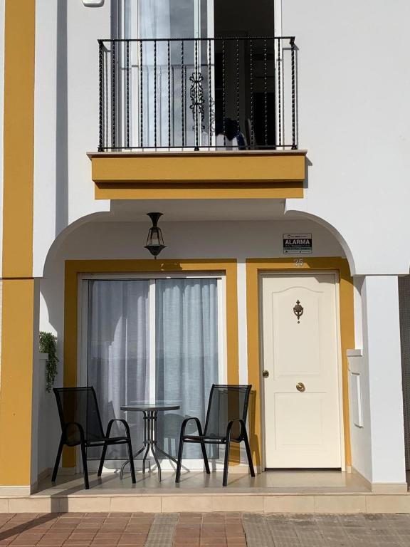 a balcony with a table and chairs in front of a building at Casa Teuwisse in Torre-Pacheco