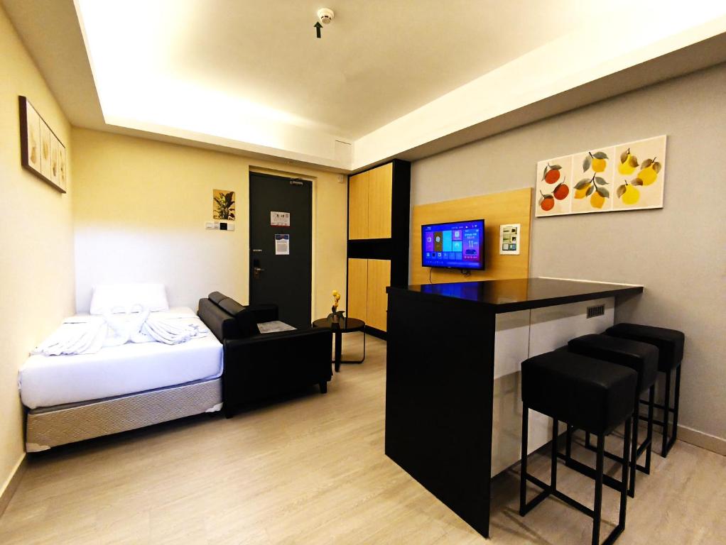 a hotel room with a bed and a bar at Genting FreezingColdInn2R1B AT Ion Delemen in Genting Highlands