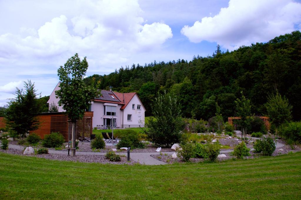 a house in the middle of a garden at Apartmány U Jeskyní in Sloup