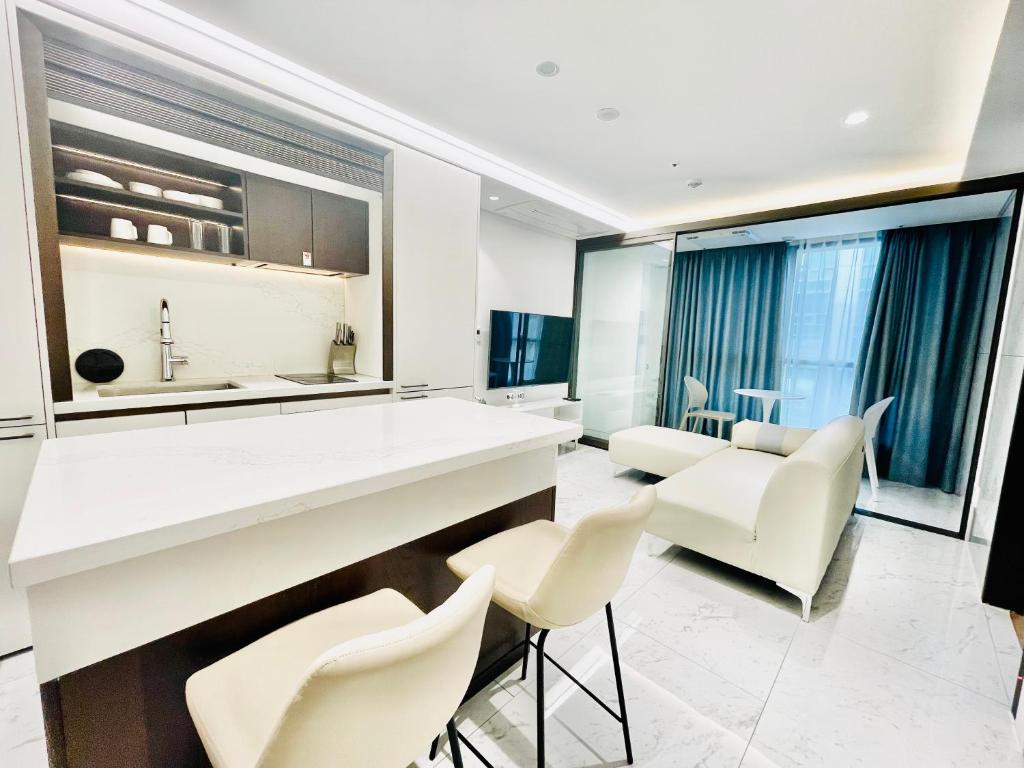 a kitchen with white chairs and a kitchen island at 서초 아트하우스2 in Seoul