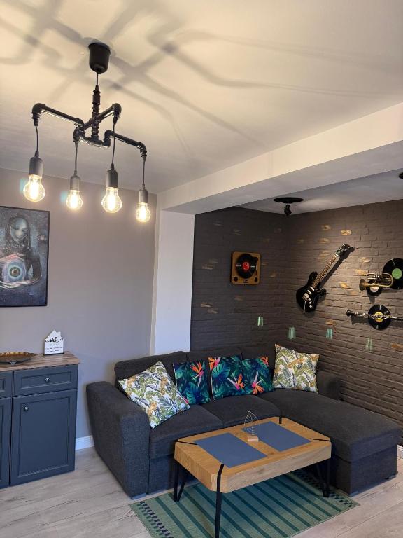 a living room with a couch and a table at Best Apartment Scheia in Suceava