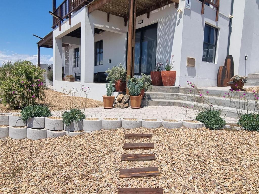a house with some plants in front of it at MaKarLi Blu in St. Helena Bay