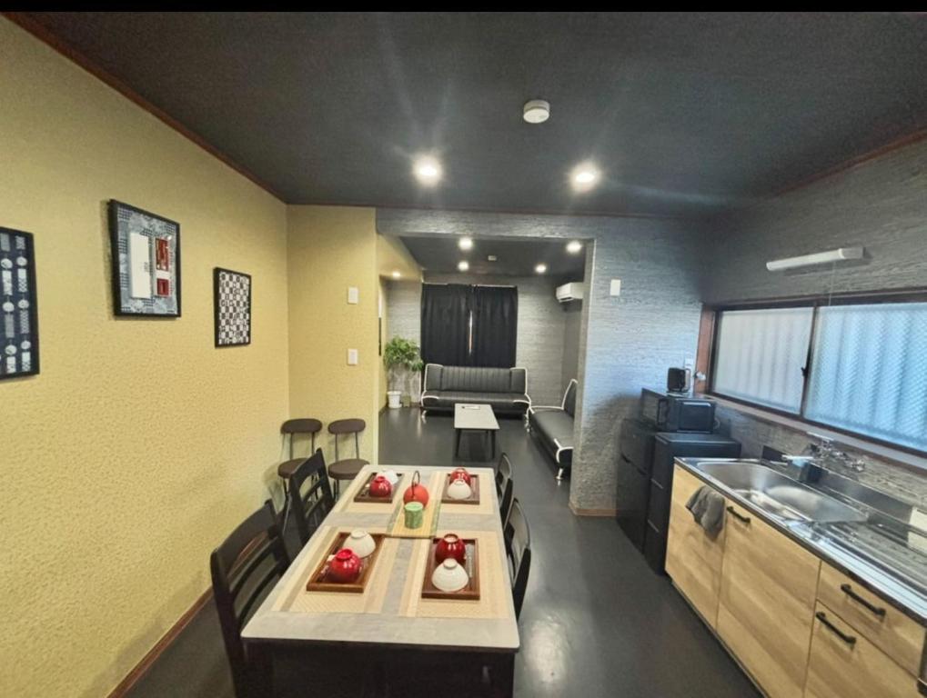 a room with a kitchen with a table and a couch at HOTTOSTAYKiyosu in Nagoya