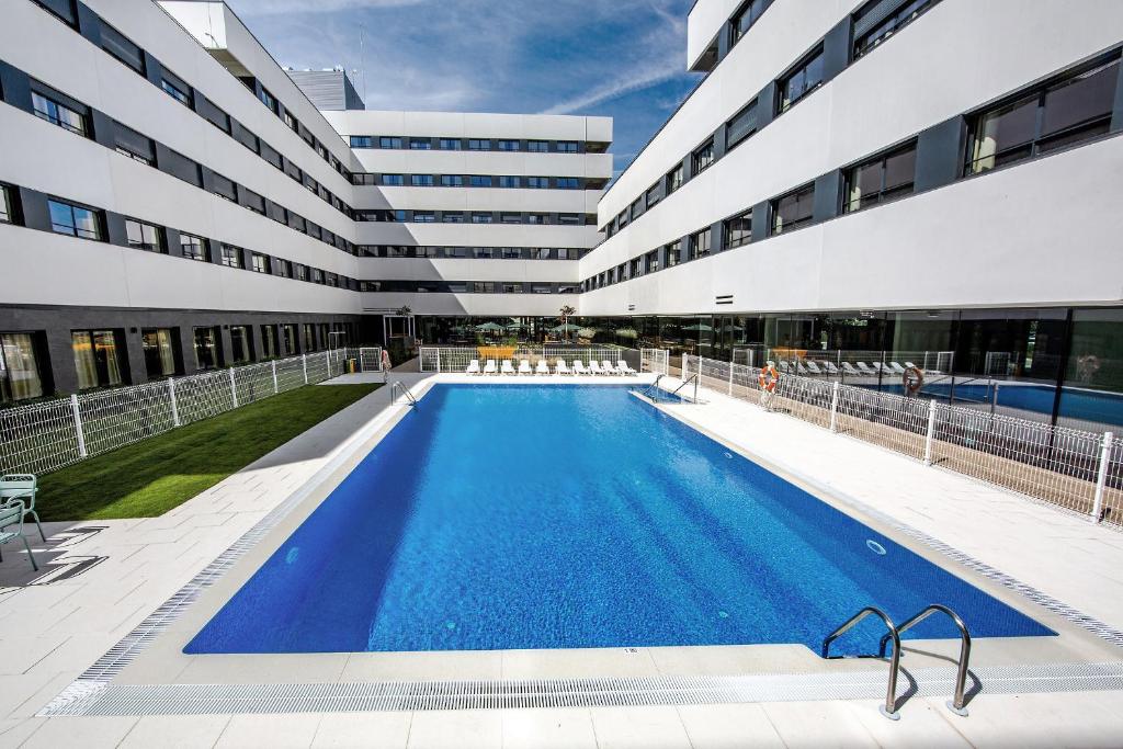 a swimming pool in front of a building at Living Experience Granada in Granada