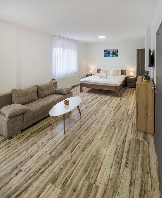 a living room with a couch and a bed at House Mila in Korenica