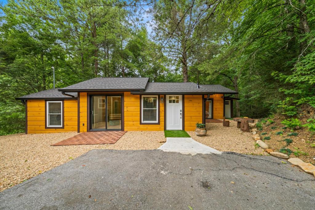 a yellow house with a driveway in front of it at Hickory Hideaway Dollywood, Island, LeConte in Pigeon Forge