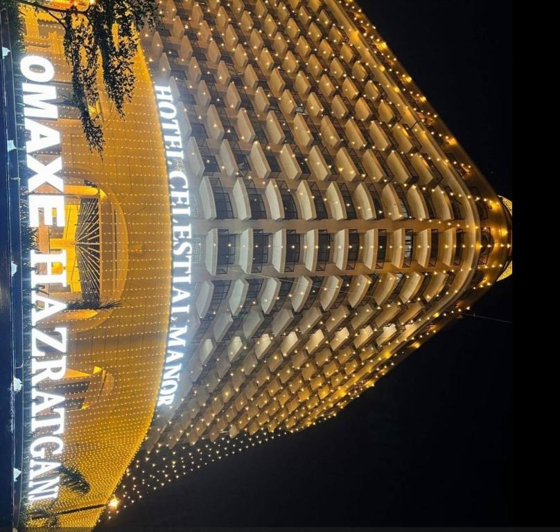 a close up of a yellow building with lights at Omex hazratganj arjunganj in Nalmatha