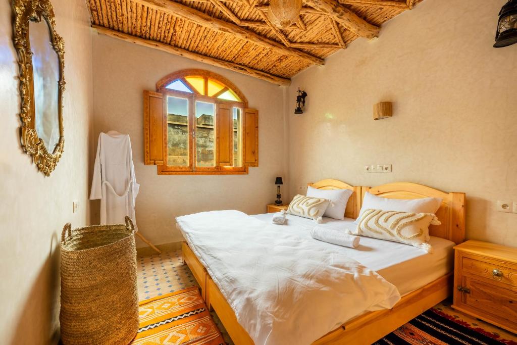 a bedroom with a large bed in a room at Berber Surf House in Tamraght Ouzdar