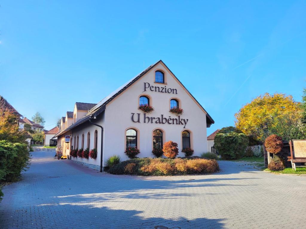 a white building with the words pentonian u patriarchy on it at Penzion U Hraběnky in Petrovice