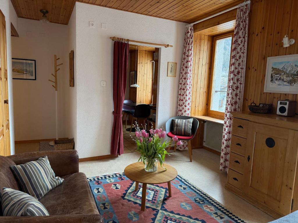 a living room with a couch and a table at Gemütliches Studio im Zentrum in Evolène