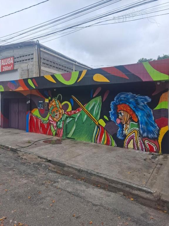 a building with a mural on the side of it at Pousada UFPE INN in Recife