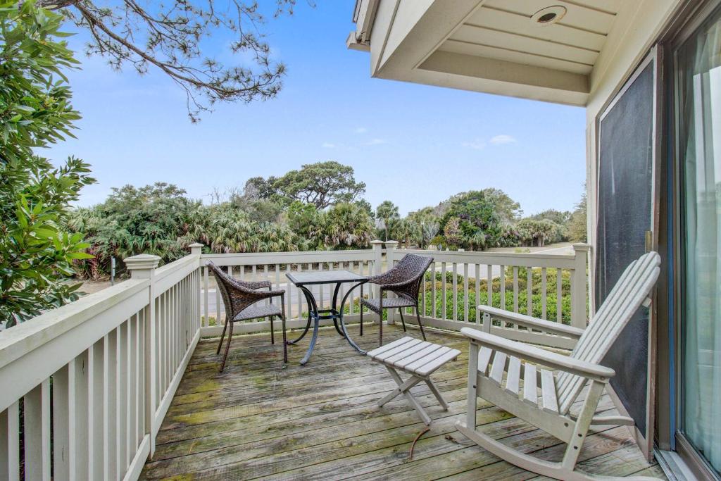 a patio with chairs and a table on a deck at Spinnaker 716 in Seabrook Island