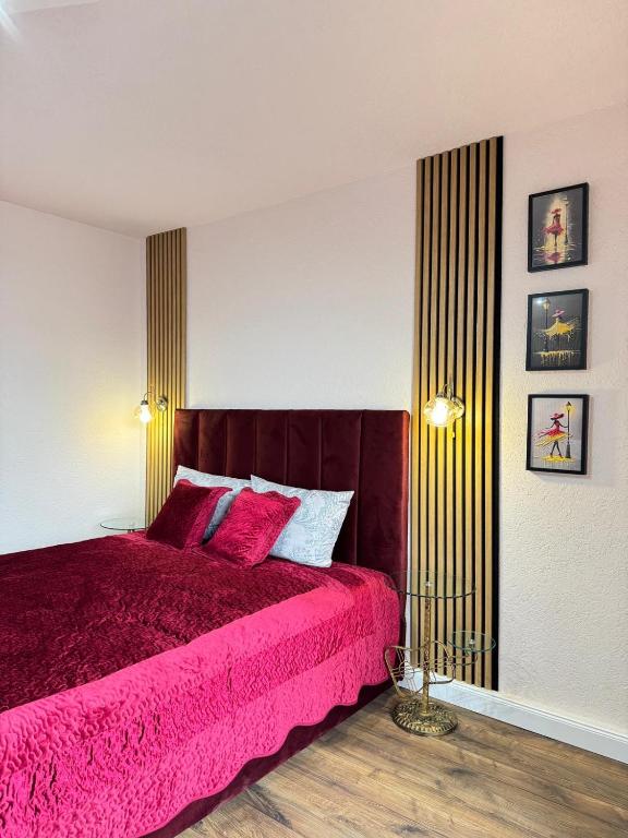 a bedroom with a bed with a pink bedspread at Riverside Apartment in Lugoj