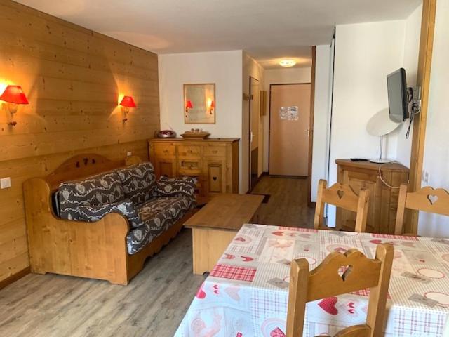 a living room with a couch and a table at Studio Brides les bains in Brides-les-Bains